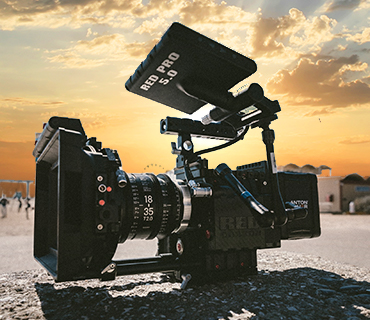 Film camera in front of a sunset Film camera in front of a sunset over the ocean