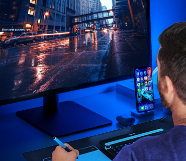 Video editor in front of a computer screen Man in front of a computer screen editing a video