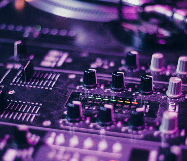 Produce electronic music Close up of a mixing desk