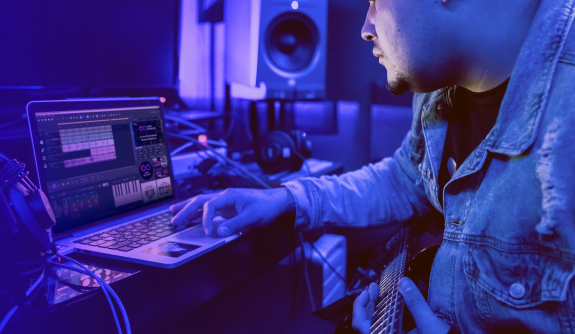 Loop-based music production Man in front of laptop with MUSIC MAKER interface