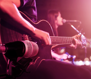 Record music Close up of person playing a guitar