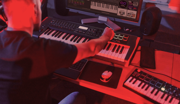 Create a remix of one of your favorite songs Man in front of a keyboard and big screen