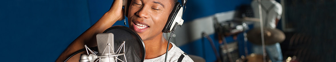 Vocal Editing: brilliance with a vocals exciter Singer with headphones in front of a mic