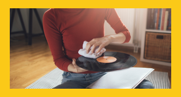 Cleaning your LP Woman cleaning an LP with a towel
